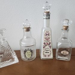 4 vintage perfume bottles with stoppers