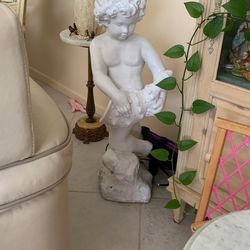 Cherub Cute Little Boy Holding A Shape Shell.