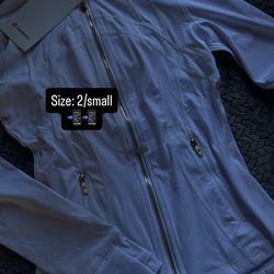 White define lululemon jacket with gold zipper