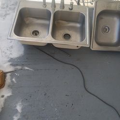 Two Double Stainless Steel Sinks With Faucets