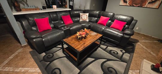 Dark gray leather sectional sofa with 2 electric recliners and 1 manual amd USB inputs on each side and inside the drink holder.... normal used betwee