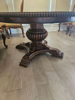 Heavy round wooden dining table
