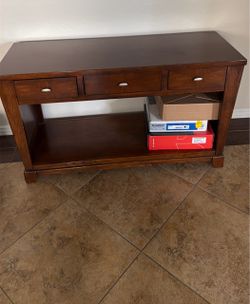 Dark brown wooden table with drawers
