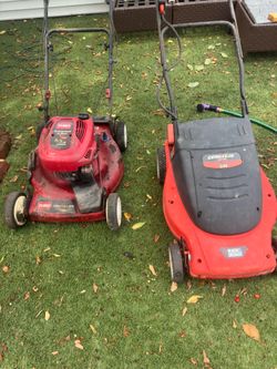 2 lawnmowers $25