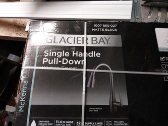 A glacier bay single handle pulled down kitchen faucet