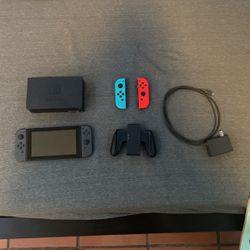 nintendo switch and 2 controllers 