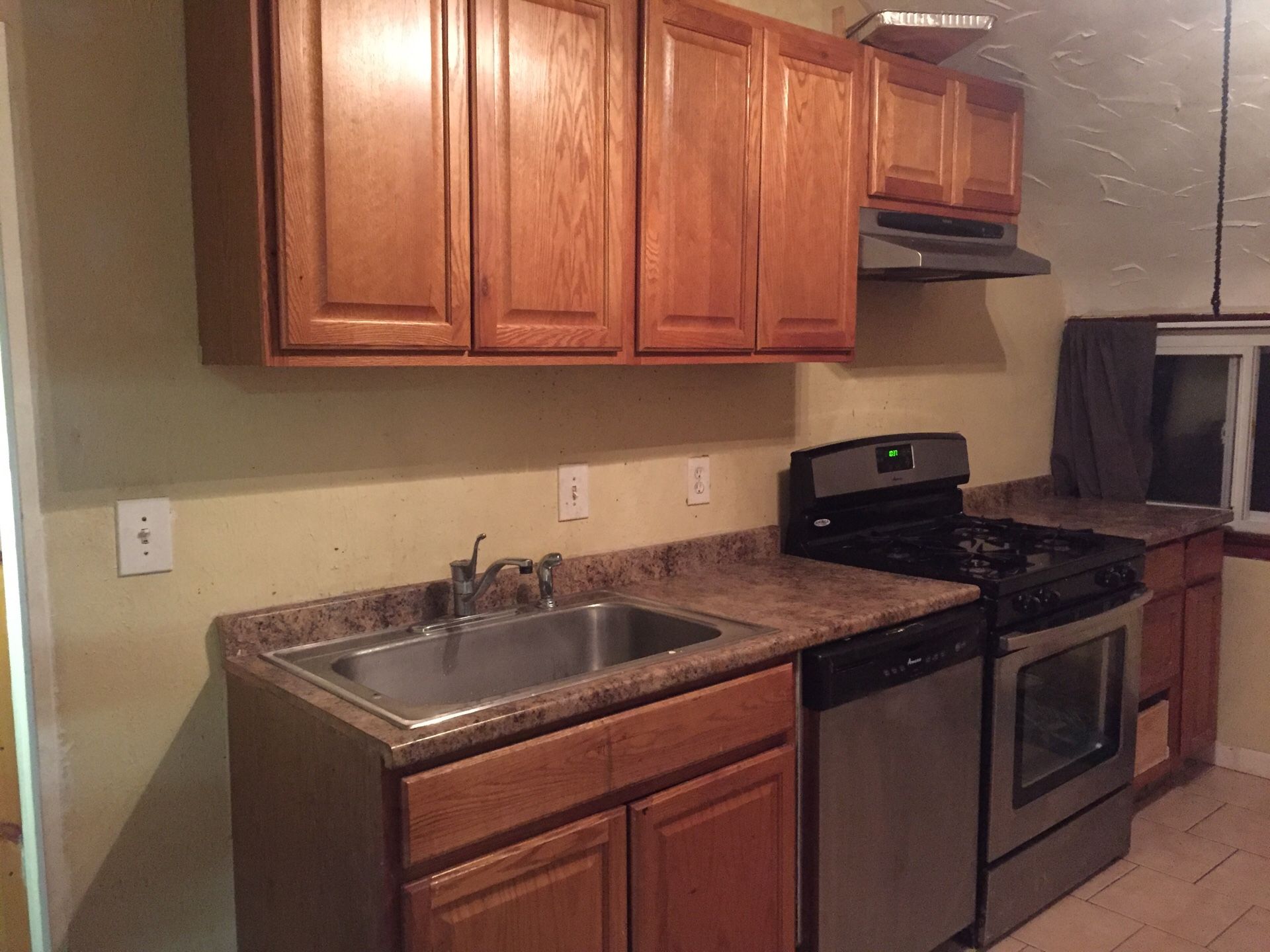 Full Kitchen with Wooden Cabinets, Double Pantry, Sink, Counter, and Vent