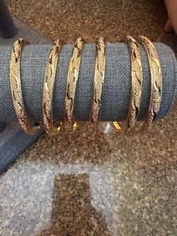7 gold plated bangles (they open to fit)
