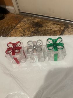 Elegant clear acrylic gift 3 boxes with decorative bows in red, silver, and green