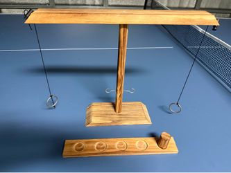 The Wood Tabletop Ring & Hook Toss Game is a classic and challenging game suitable for ages 17 and up. Made from high-quality brown wooden materials, 