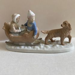Meico Porcelain Figurine Featuring a Girl And Boy In a Sleigh With A Dog 