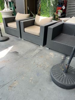 Rattan patio set with minor damage (shown in the photos); some cushions are missing.