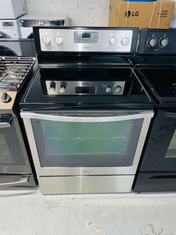 Whirlpool stainless steel electric stove—includes a receipt for a 90-day warranty.