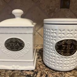 2 ceramic tea canisters with lids, white, good condition. cash only