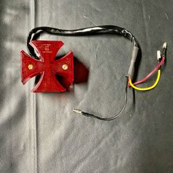 Red cross-shaped tail Light
