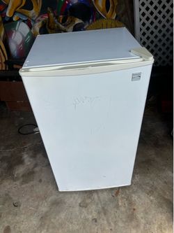 Kenmore compact mini fridge with a single door.