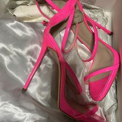 Giuseppe Zanotti neon pink patent leather stiletto. This high-end designer piece typically features a strappy silhouette