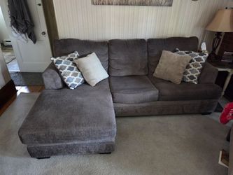 L shape couch with pillows