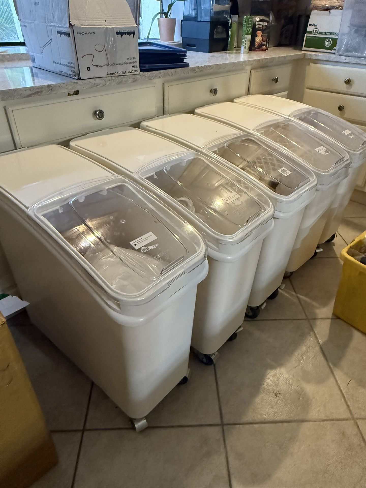 Used Winco ingredient storage bins with sliding lids and wheels