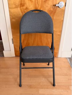 Three Black Upholstered Folding Chairs