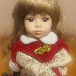 Accents & Occasions Porcelain Doll, blond hair,  Christmas red, gold dress stand