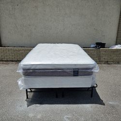 Brand New full-size plush pillow top mattress and box spring in plastics 