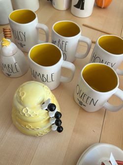 Rae Dunn Bee mugs with honey pot and bee measuring cups from bake shop