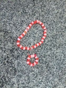 Homemade orange and tan bracelet and necklace.