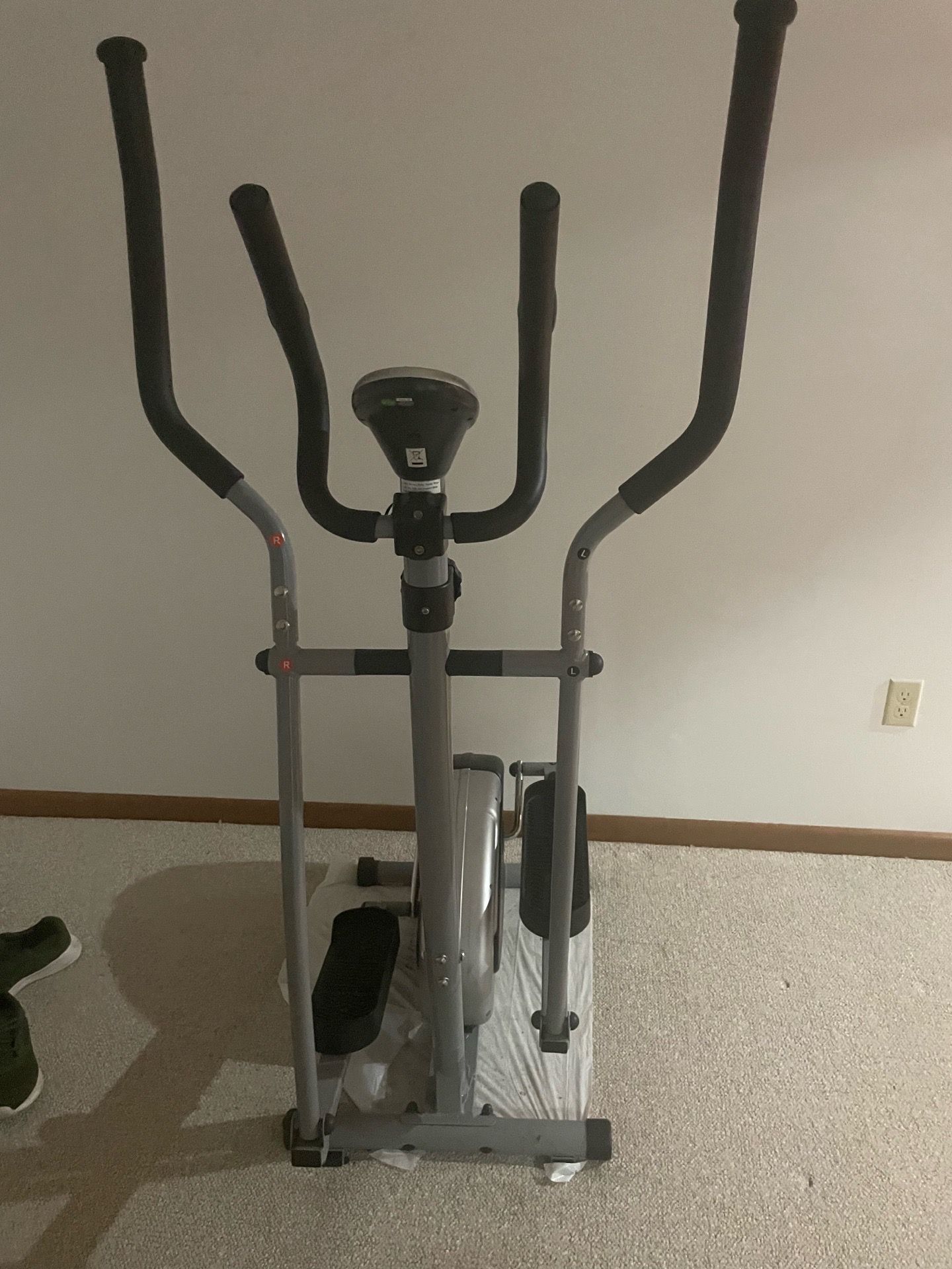 This is a grey Sunny Health & Fitness elliptical trainer.
