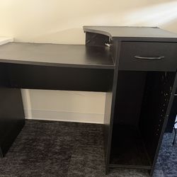 Very light but sturdy black office desk.