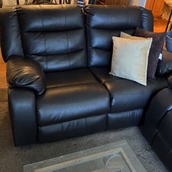 Brown leather couch and loveseat with pillows