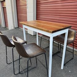 Wooden high table and four chairs