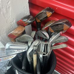 collection of used golf clubs,