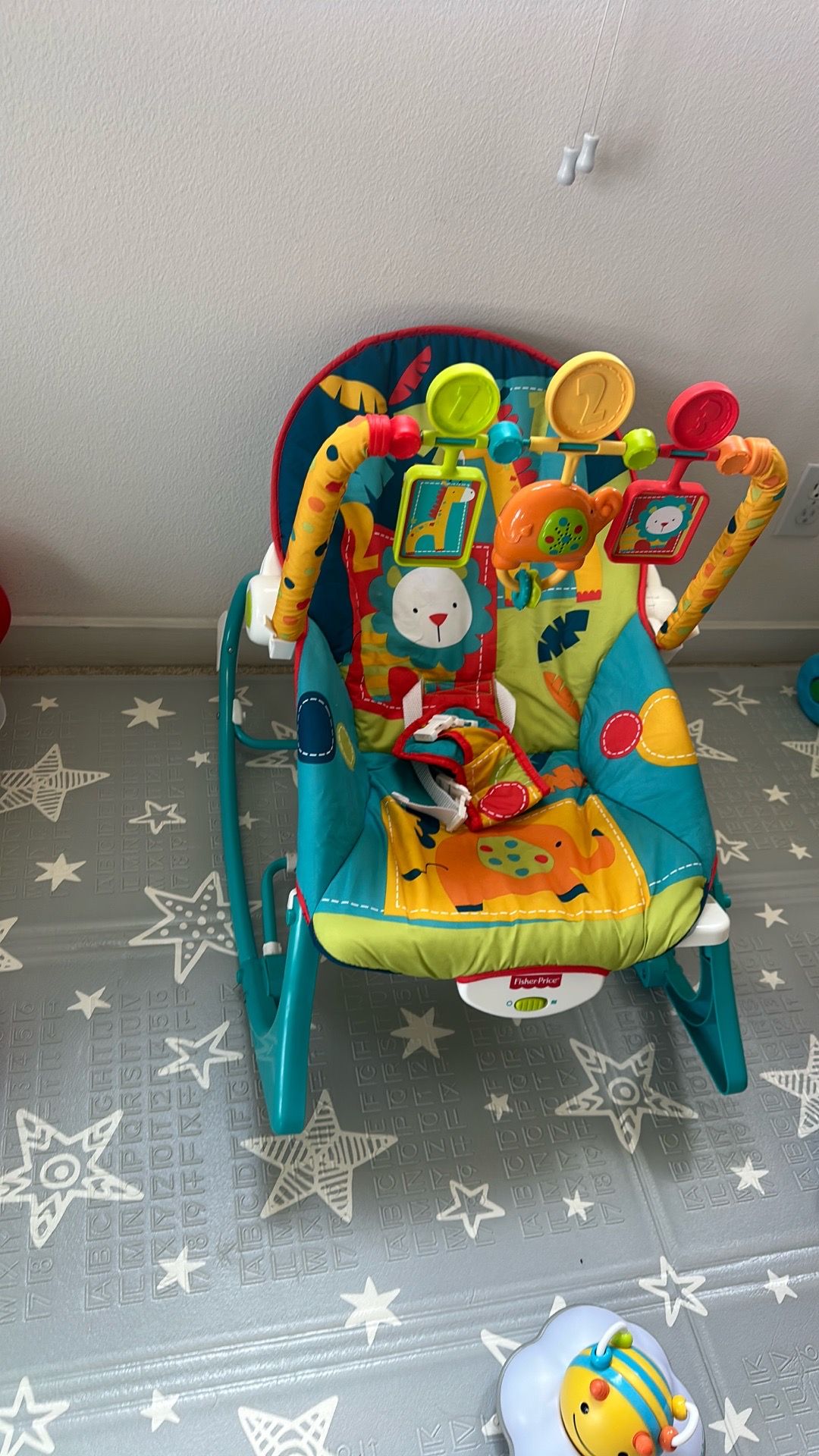 Fisher-Price Infant-to-Toddler Rocker featuring a colorful jungle animal design and a toy bar.