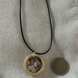 Necklace, Wood , Stone, And Shell Are The Materials