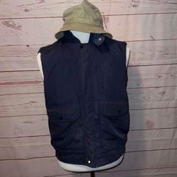 vintage Expeditions fishing vest w/hood Quilted lining  Polyester/cotton outside  Nylon inside Hidden drawstring hood rolls and zips up in collar.