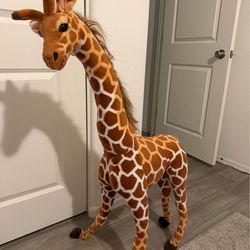 Two large decorative stuffed animal giraffes