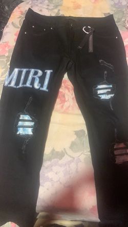 Amiri Black Distressed Jeans with Blue Patches