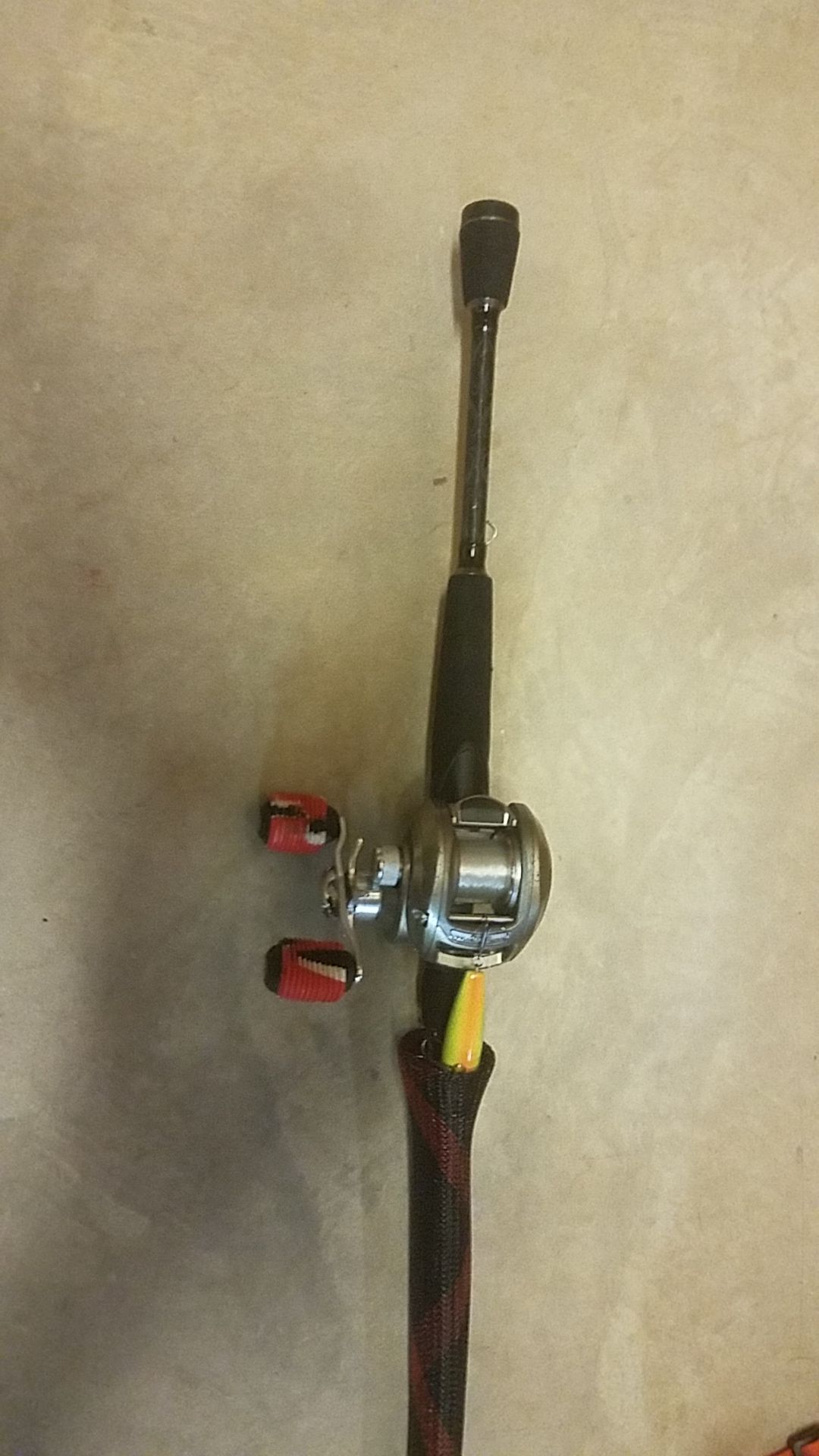 Bass Pro Shop baitcaster with a good bit of bait and fishing stand