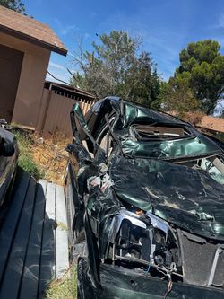 Totaled Green 2002 Cadillac Escalade for Parts or Salvage