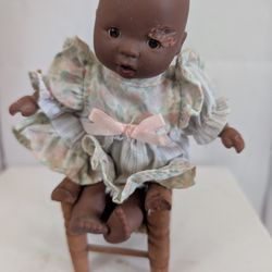 Tiny Doll On A High Chair