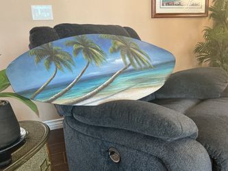 Painting beach scene on surf board shaped board