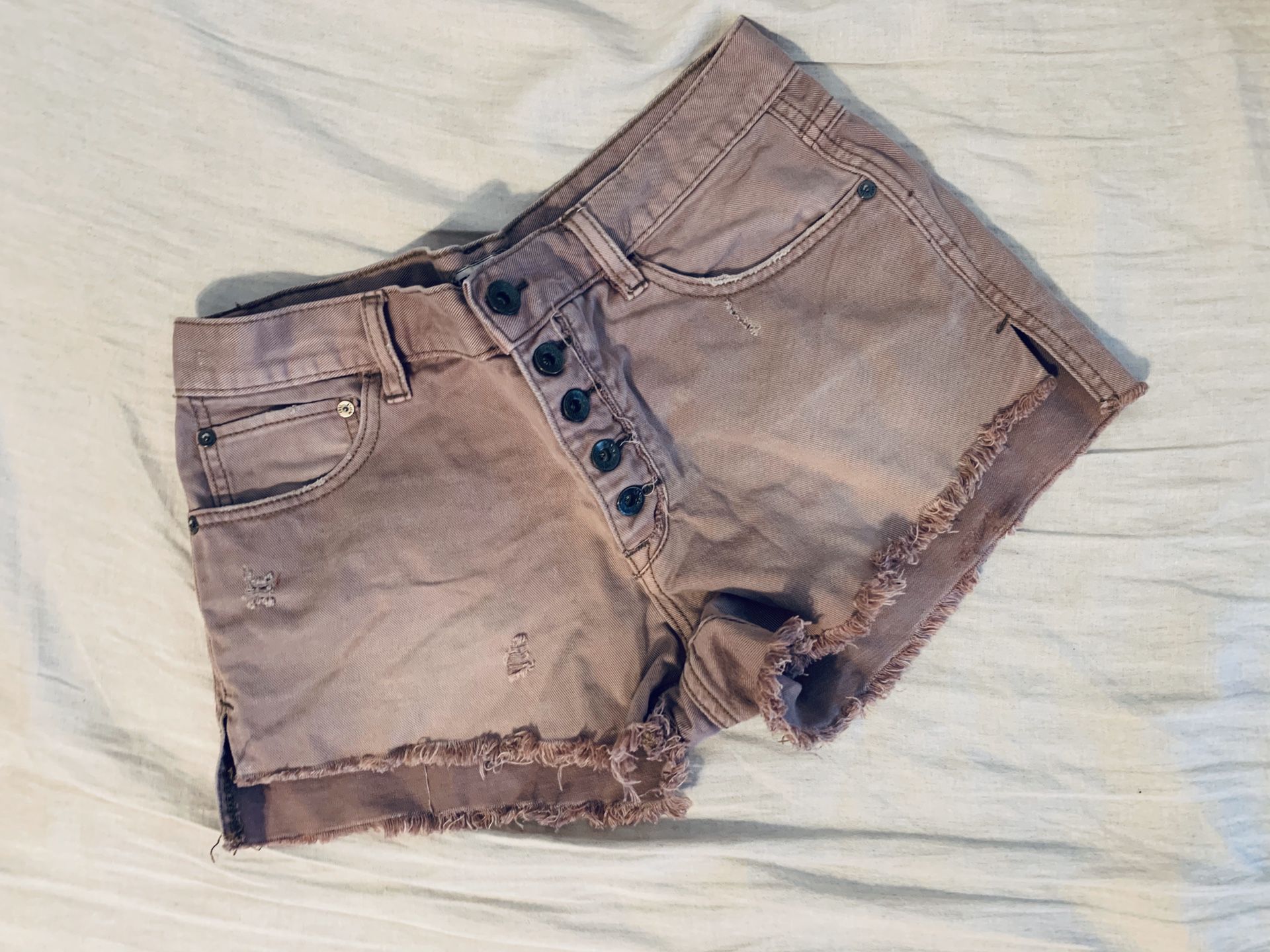 Free people fringe shorts with buttons details .