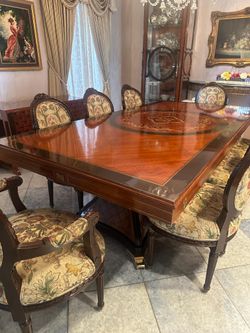 Elegant Carved Wood Dining Table with Ornate Floral Upholstered Chairs