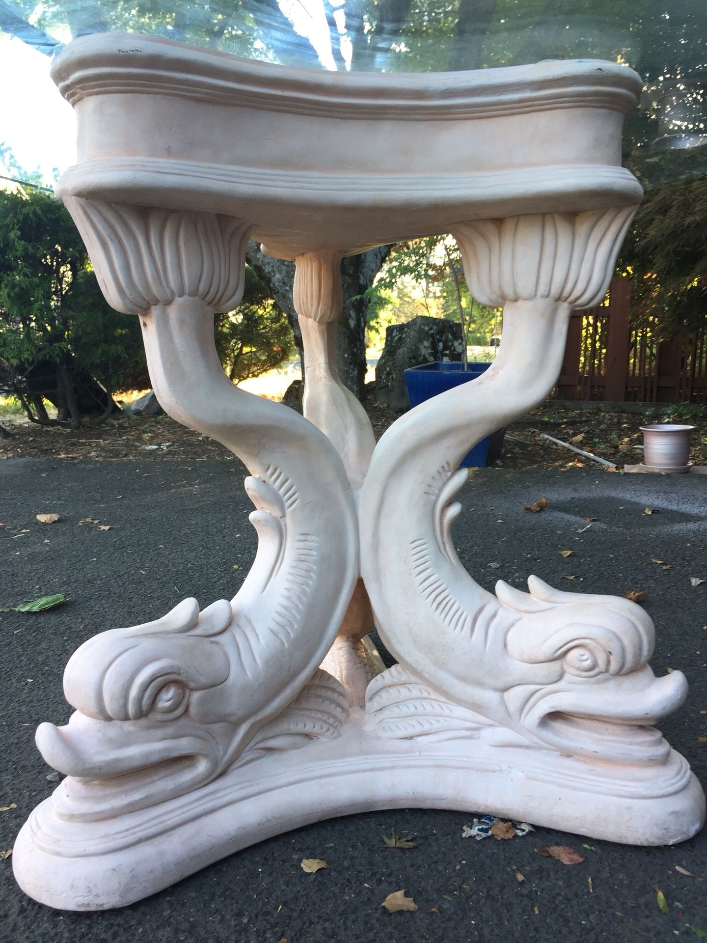 Artistic glass table with carved koi fish base