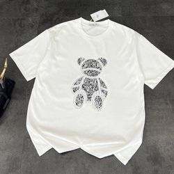 The T-shirt is printed with the classic Dior bear pattern