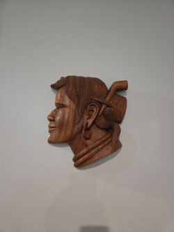 A carved vintage wooden wall sculpture