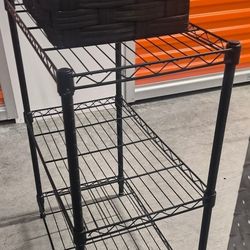 3 Tier Storage Rack And A Black Wicker Storage Container Decoration 