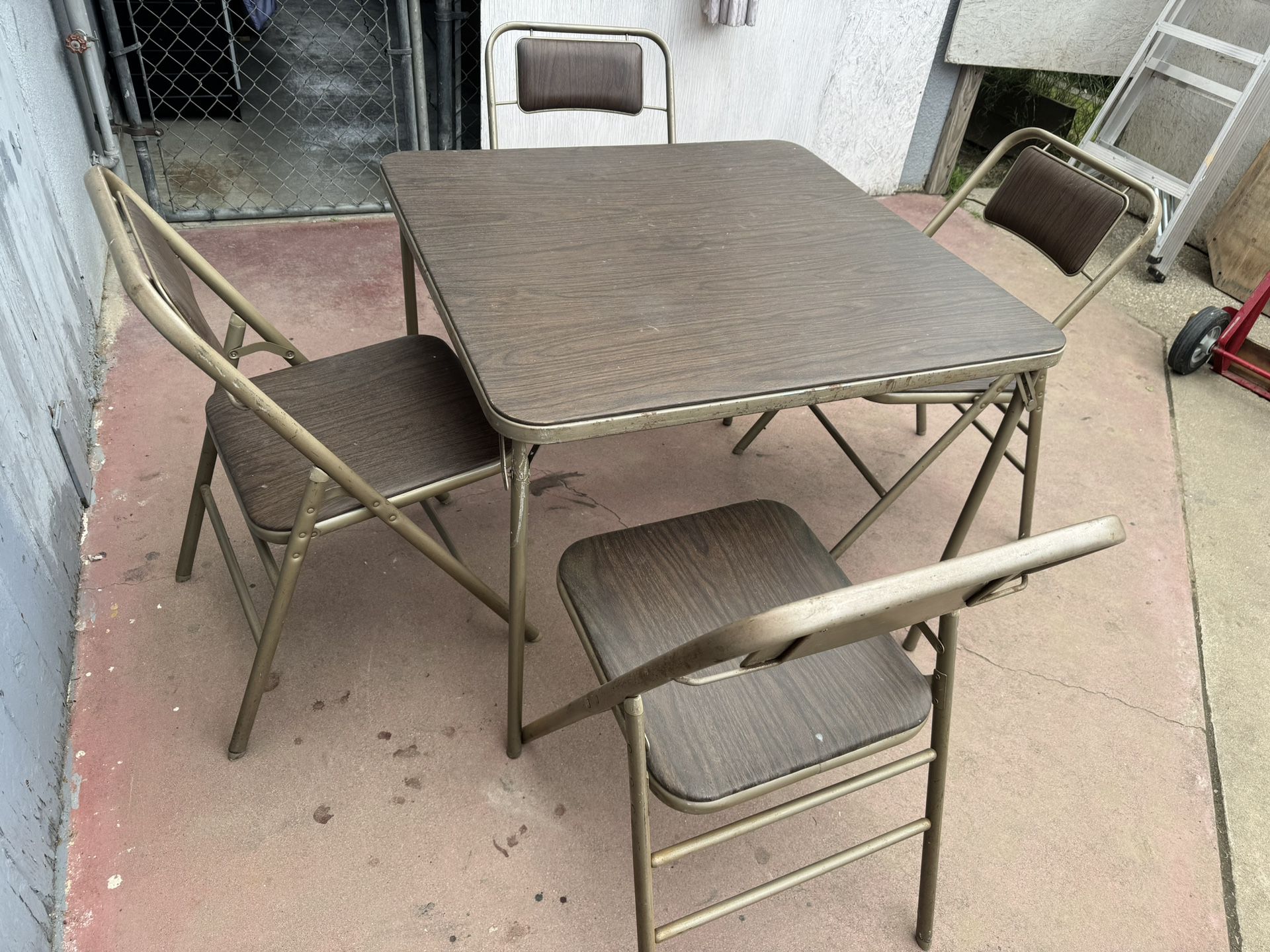 Metal Table And Four Regular Chairs In Good Condition