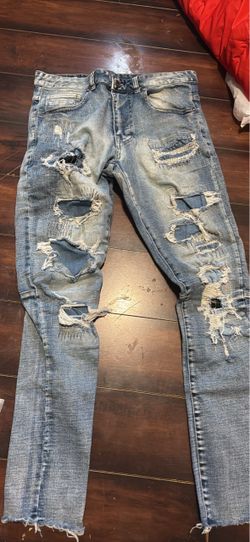 Heavily Distressed Light Wash Denim Jeans